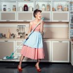 Woman sings and cleans the house.